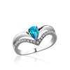 Sterling silver ring with cz's and center blue topaz