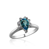 Sterling silver ring with cz's and center blue topaz